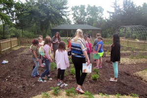 Truman MAE students teach a lesson outdoors to students in the summer school program.