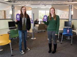 Students Kaitie Otto (left) and Abagale Casagrande show off two of the many tags that were placed  around campus to highlight donor contributions.