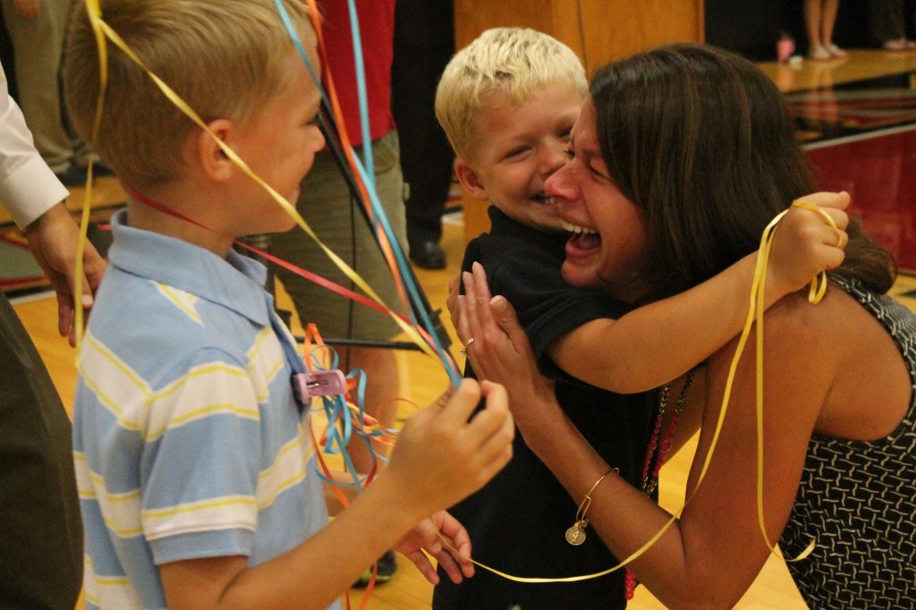 ABOVE: Jamie Manker shares a moment with her two sons, Kyle (7) and Tyler (5) after learning she was named the Missouri Teacher of the Year. (Photo by Mary Thaier, Rockwood Summit, Talon Newspaper) 