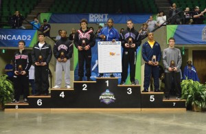 Ryan Maus stands on the podium after earning third place in the NCAA Division II Wrestling championships. 