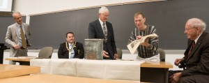 Charles Tharp reveals a school newspaper from the 1954 Science Hall time capsule, which was opened in May. Pictured, from left to right: University President Troy Paino, Jon Broyles of the Freemasons, Professor Emeritus Max Bell, Tharp and President Emeritus Jack Magruder.