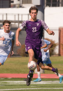 Jacob Panagos kicking soccer ball