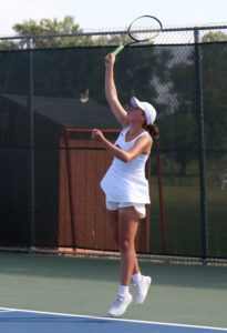 Sydney Dial serving tennis ball