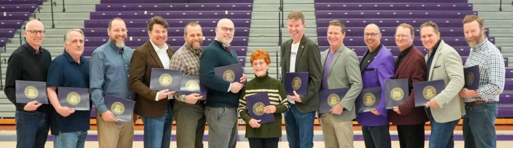 Men's cross country team inducted into the Truman Athletics Hall of Fame hold awards in Pershing arena